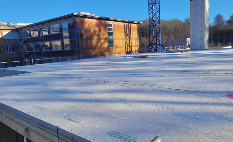 Public school building in CLT under construction in Germany, prefabricated panels ready for assembly