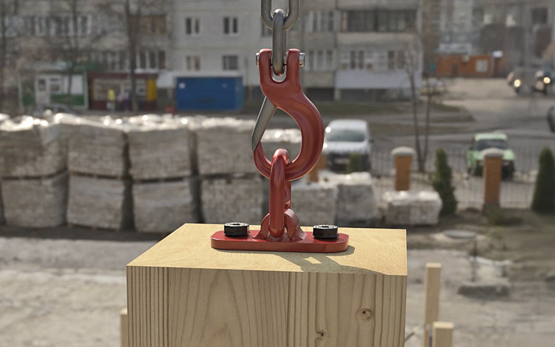 Metal lifting hook and plate fixed to timber element for crane lifting on construction site, designed for handling prefabricated wooden components 
