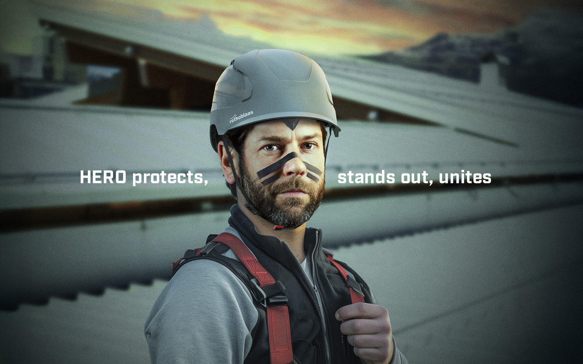 Worker wearing Rothoblaas HERO safety helmet in grey and a safety harness, in an industrial setting